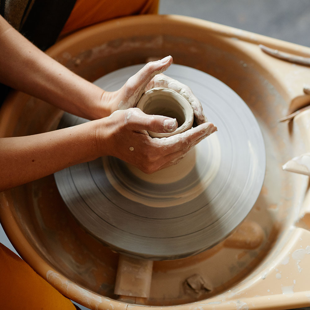 hands-shaping-ceramics-on-pottery-wheel